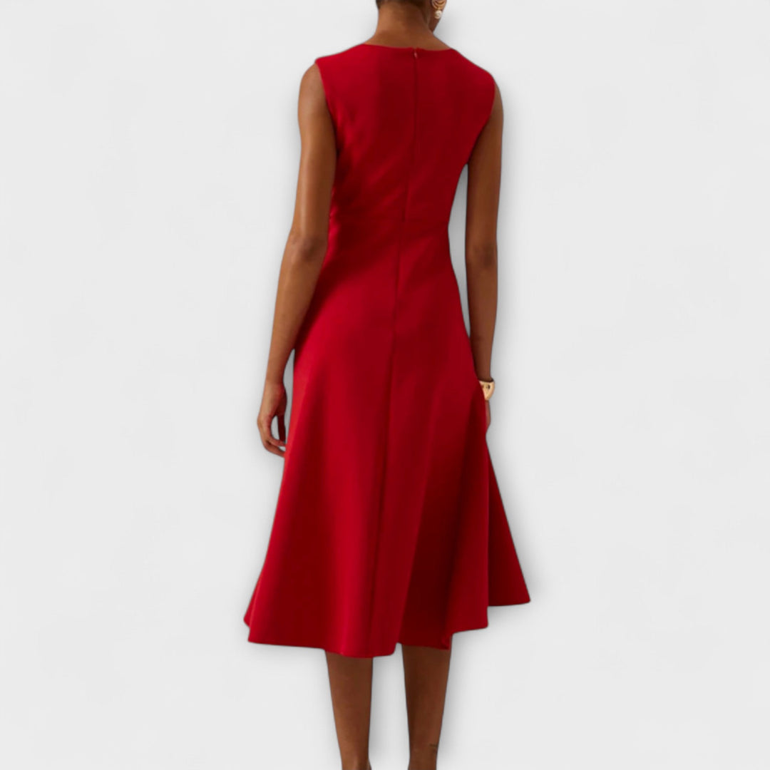 Elegant sleeveless midi dress featuring a unique asymmetric detail, perfect for chic occasions and flattering all body types. 1