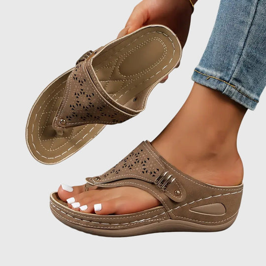 Orthopedic sandals for women featuring a shock-absorbing sole and a convenient slip-on design, providing ergonomic support and ultimate comfort for all-day wear. 1