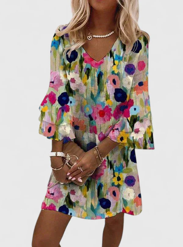 Women's mini dress featuring a flattering V-neckline and vibrant floral print, perfect for playful summer outings; available in plus sizes. 0