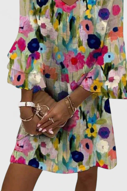 Women's mini dress featuring a flattering V-neckline and vibrant floral print, perfect for playful summer outings; available in plus sizes. 1