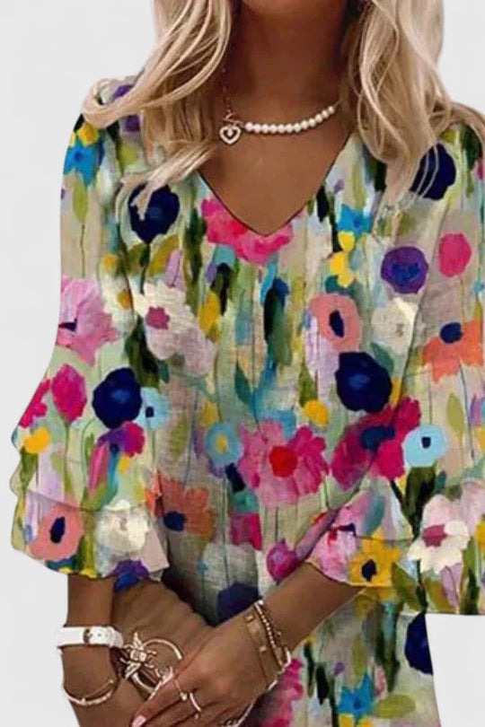 Women's mini dress featuring a flattering V-neckline and vibrant floral print, perfect for playful summer outings; available in plus sizes. 2