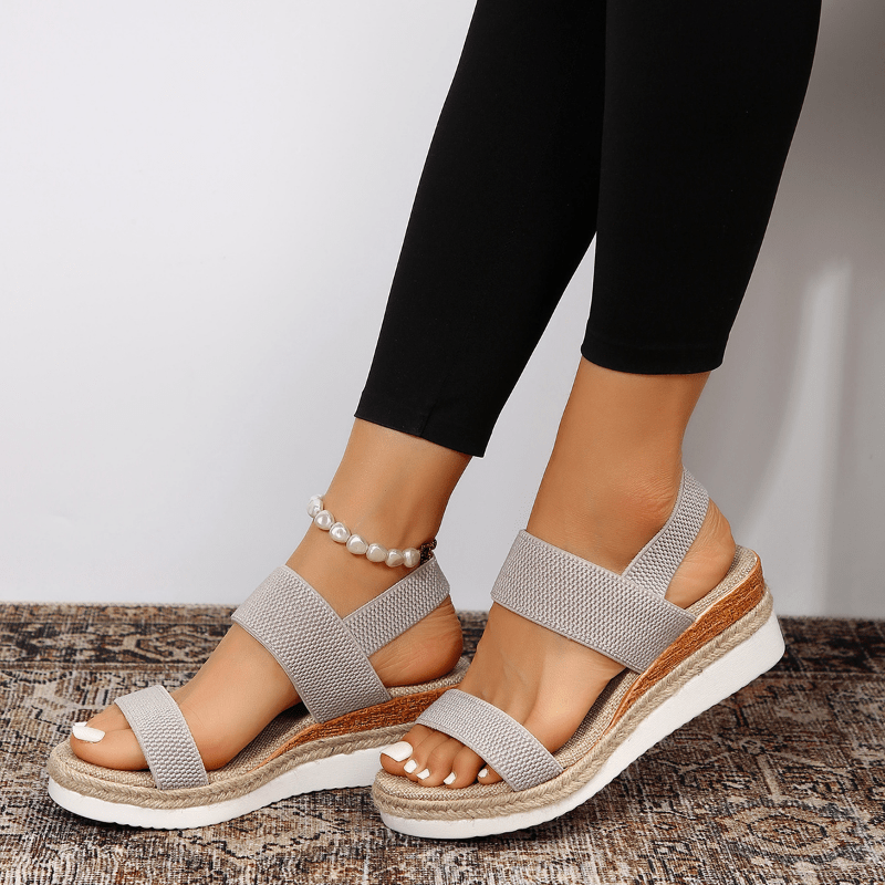 Women's platform sandals featuring elastic straps and a sporty sole, designed for lightweight comfort and breathability. Ideal for casual outings and summer wear. 8