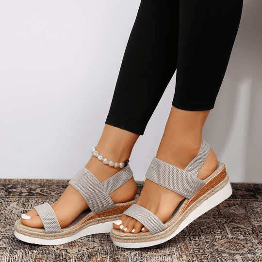Women's platform sandals featuring elastic straps and a sporty sole, designed for lightweight comfort and breathability. Ideal for casual outings and summer wear. 8