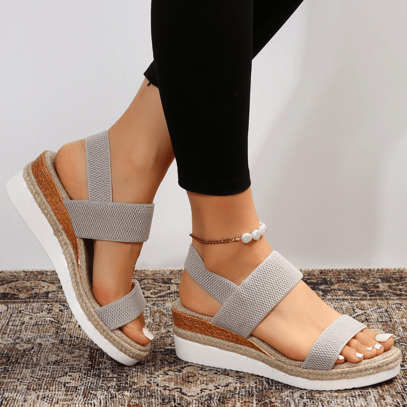 Women's platform sandals featuring elastic straps and a sporty sole, designed for lightweight comfort and breathability. Ideal for casual outings and summer wear. 9