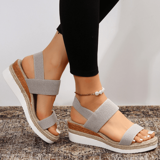 Women's platform sandals featuring elastic straps and a sporty sole, designed for lightweight comfort and breathability. Ideal for casual outings and summer wear. 9